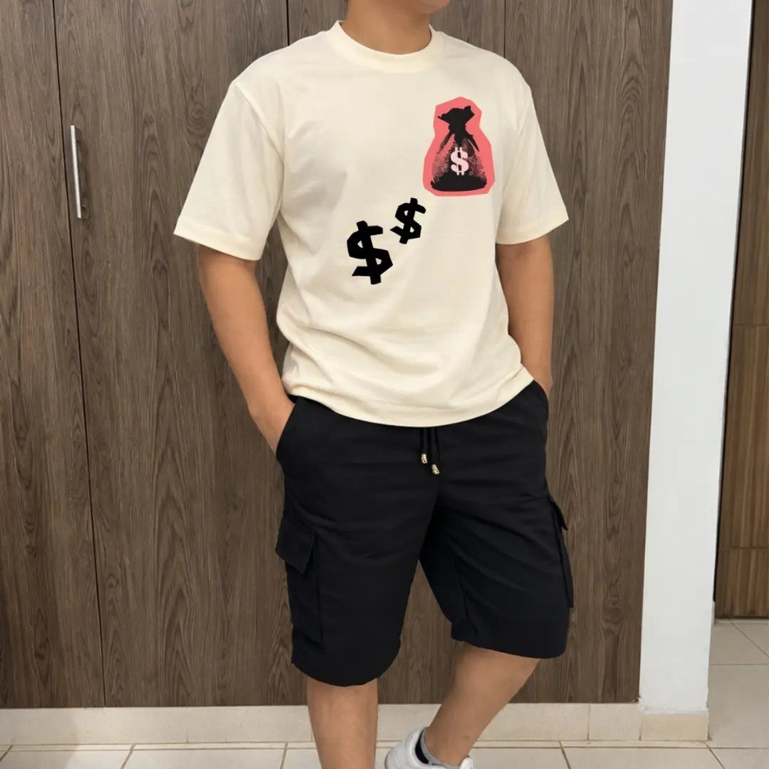 A person wearing a cream graphic t-shirt and black cargo shorts standing before a wooden cabinet.